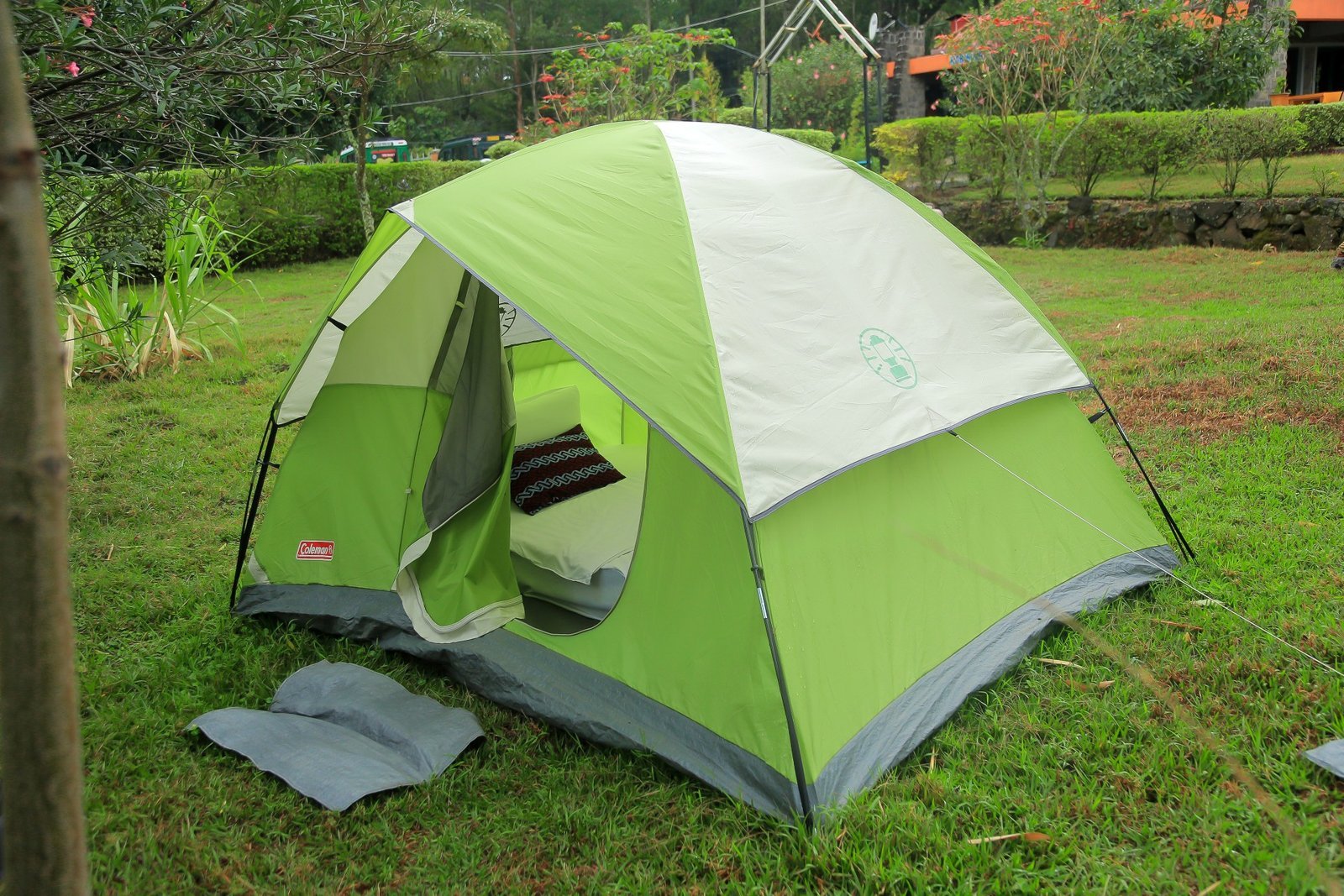 Green and white dome tent pitched on the resort lawn