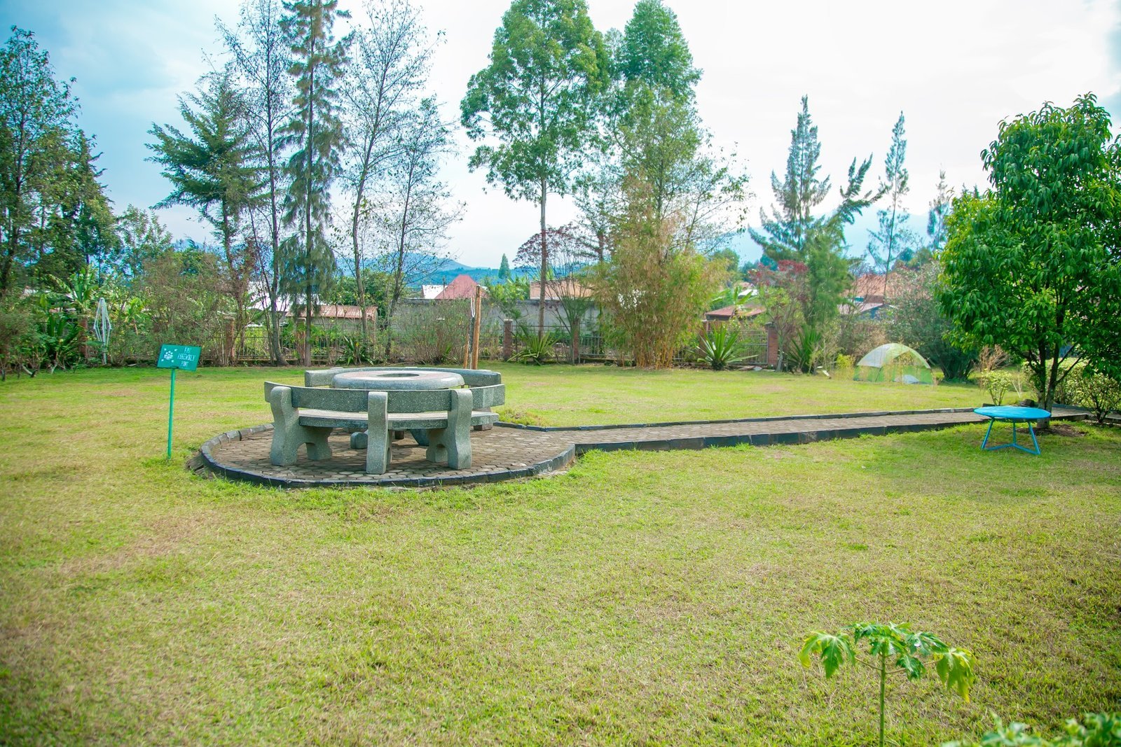 Circular stone seating on a paved path in the garden
