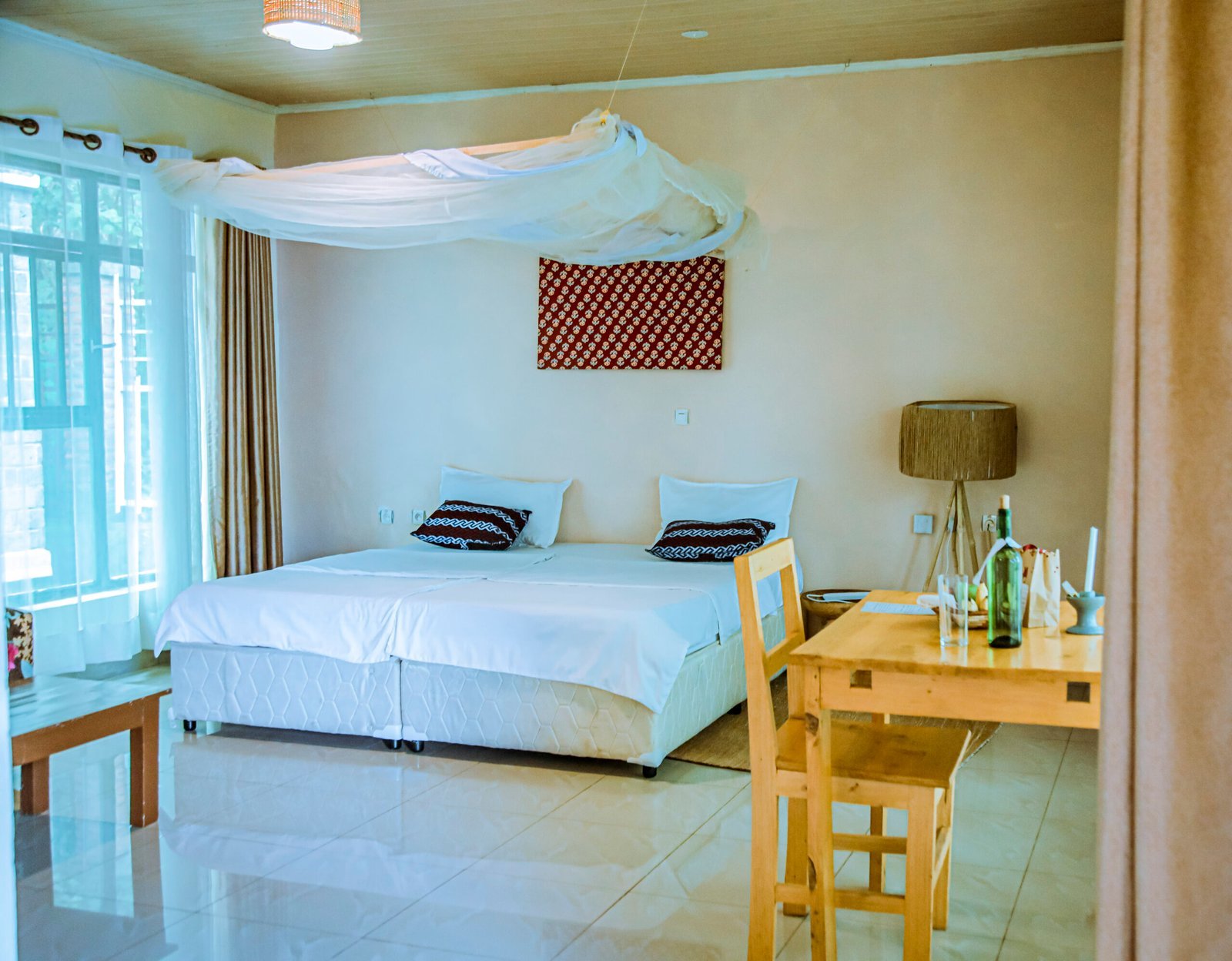 Woven decor, patterned textiles and a bedside lamp in an African-style room at the resort