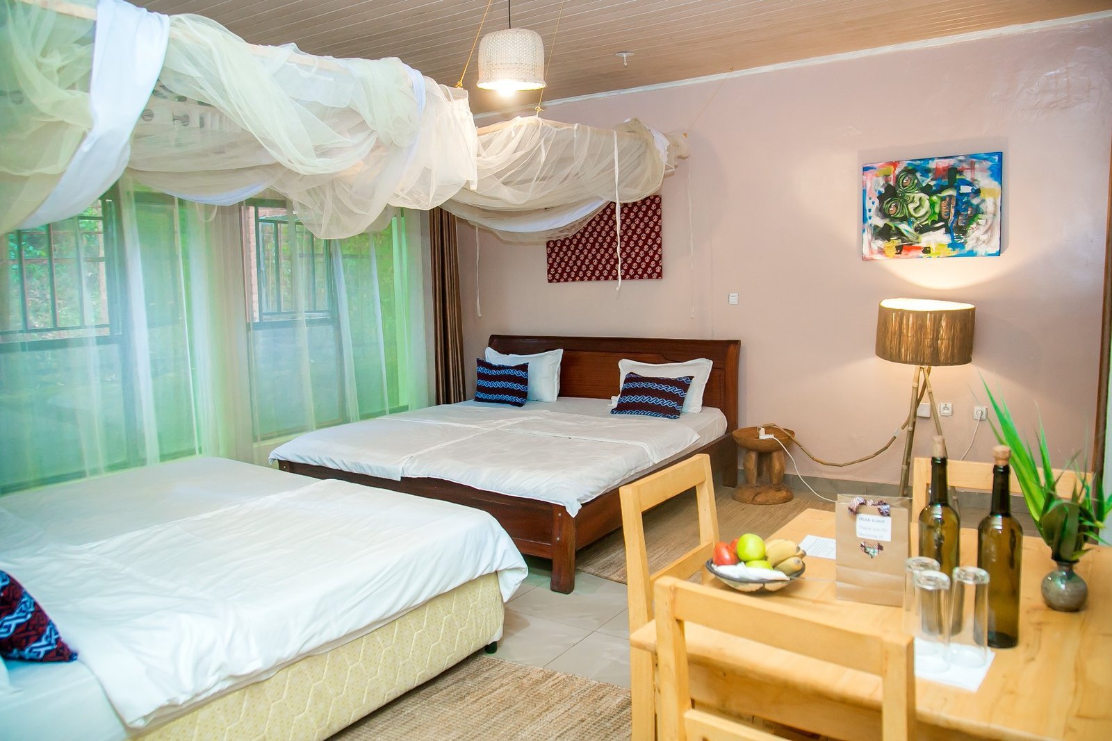 Family room with two beds, a canopy net and a painted wall